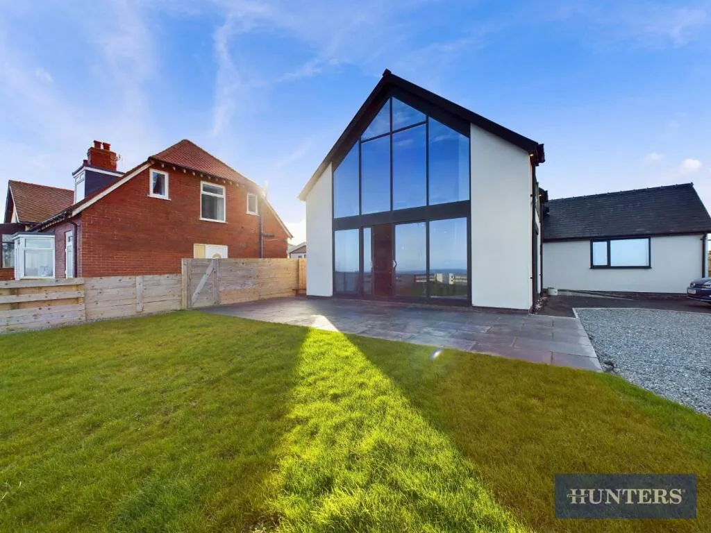 Castle Sunset on the Beach: the tall glass gable at the front of the house, above the lawn